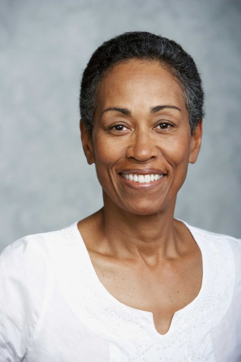 smiling-woman-in-a-white-blouse-posing-for-a-portr-2024-07-03-23-25-24-utc